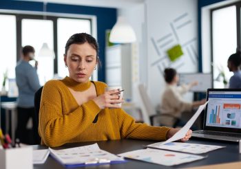 Management of financial company reading statistics in workplace